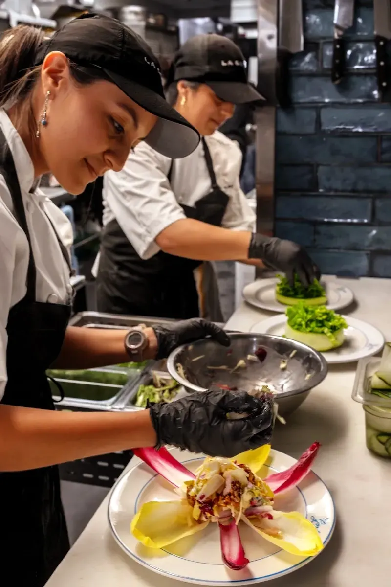 The kitchen team plating dishes