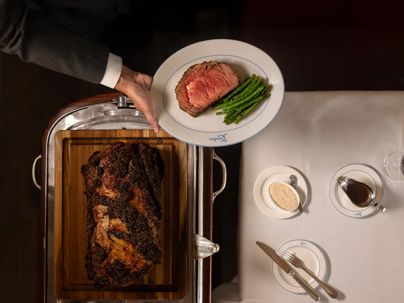 Prime rib carved tableside on its silver cart