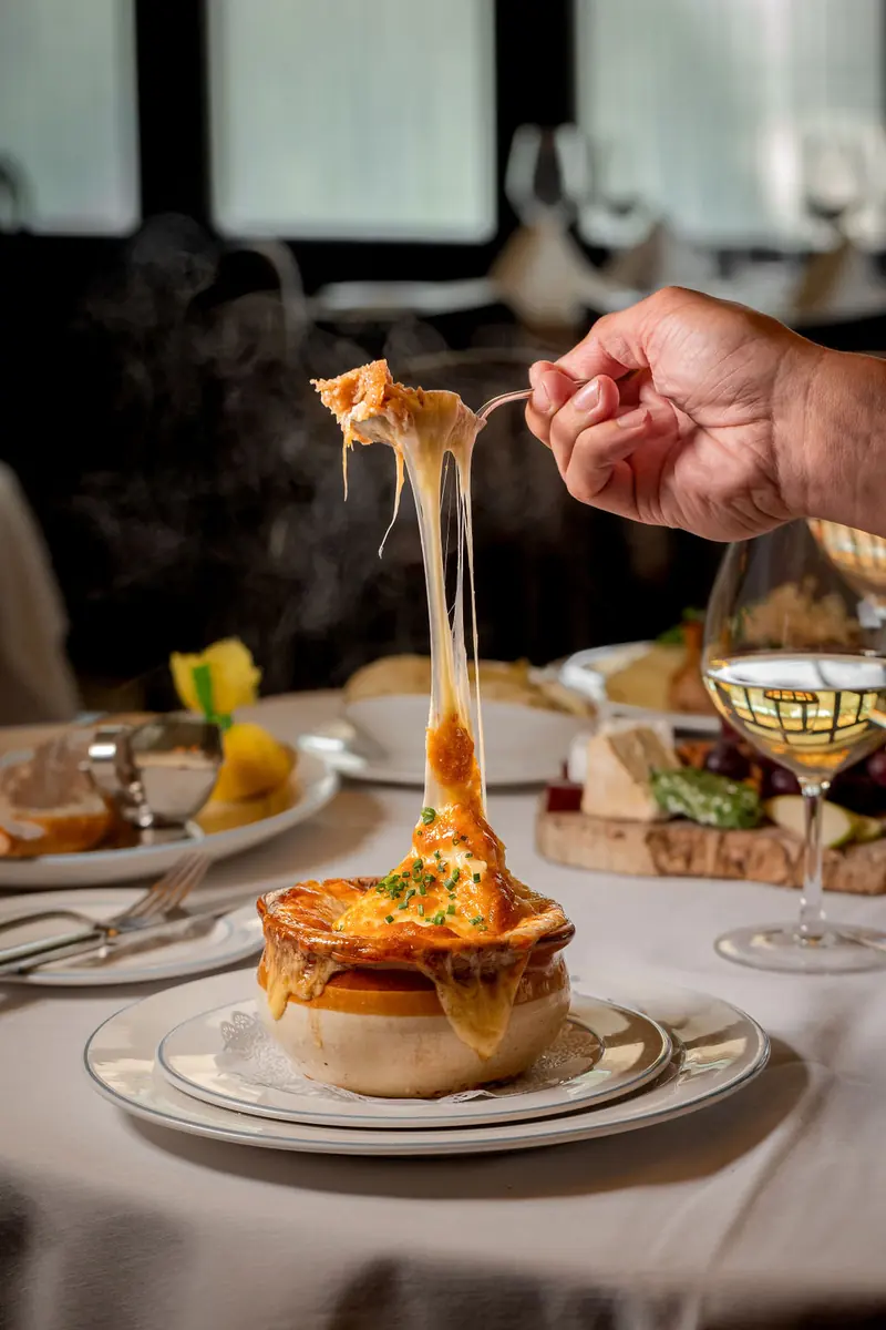 Soupe à l'Oignon Gratinée with a pull of melted cheese