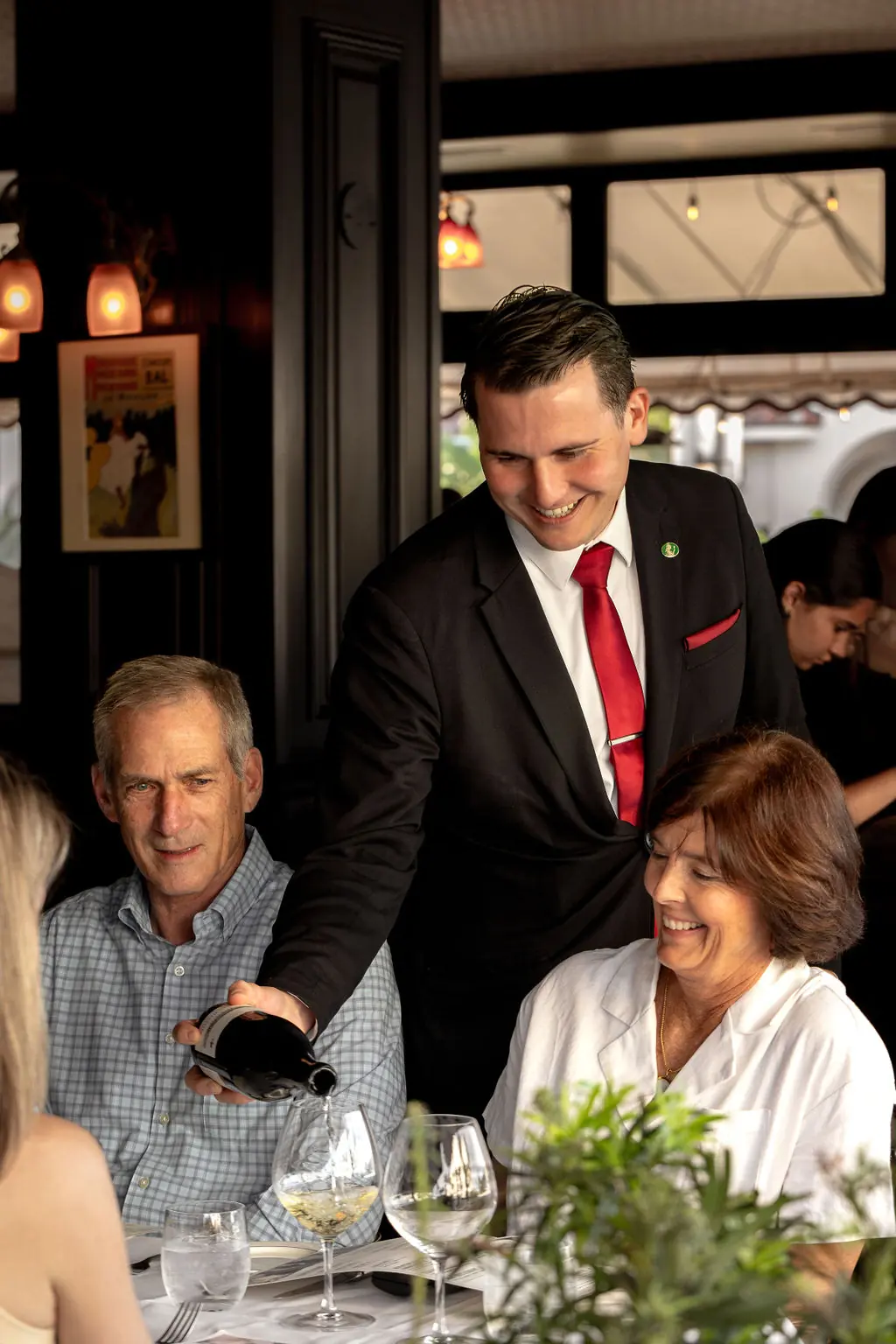 White wine poured for guests at the table